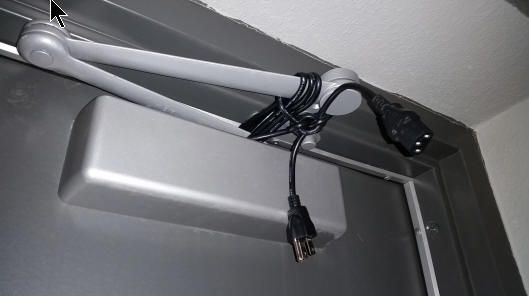 Cord being used to hold a door shut during a windy day.